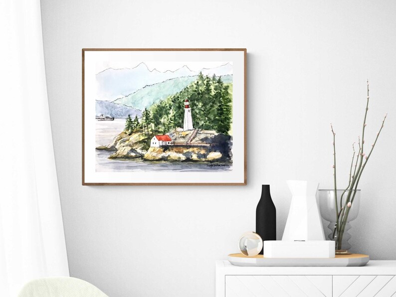 May include: Watercolor painting of a lighthouse on a rocky island with a red roofed house and green trees in the background. The lighthouse is white with a red roof and a black and white striped top.