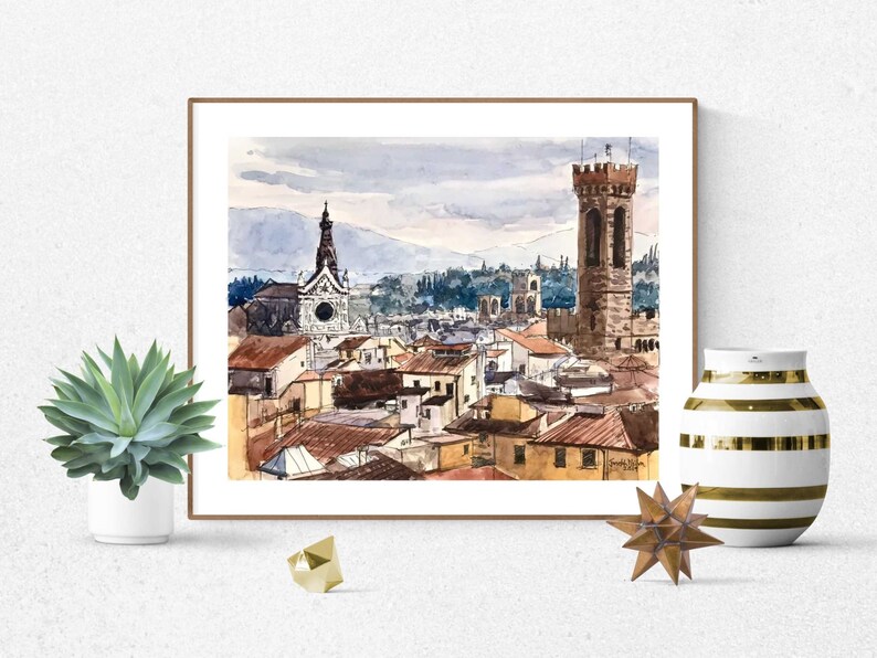 May include: Watercolor painting of a cityscape with a tall tower and a church in the background. The buildings are painted in shades of brown, orange, and yellow. The sky is a light blue with some clouds.