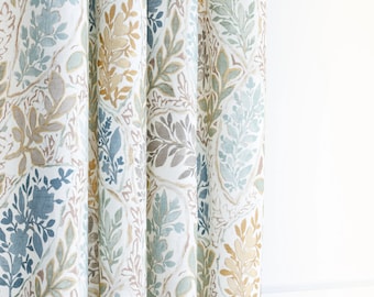 May include: A fabric curtain featuring a repeating pattern of botanical motifs in shades of blue, sage green, and muted gold. The design consists of stylized leaves and floral elements arranged within an interlocking, diamond-shaped grid layout.
