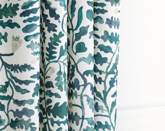 This soft, linen-blend drapery botanical print in a palette of deep teal and forest green with blush floral accents, off white backdrop.