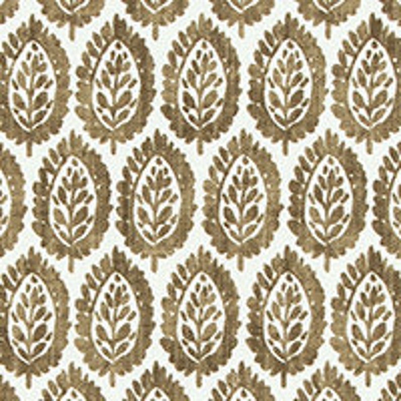 May include: A white background with a repeating pattern of brown leaf-like shapes. The shapes are stylized and resemble a traditional Indian paisley design.