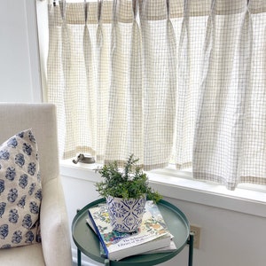 This pleated cafe curtain has a fresh cream linen windowpane plaid subtle subtle pattern perfect for fall
