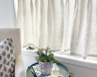 This pleated cafe curtain has a fresh cream linen windowpane plaid subtle subtle pattern perfect for fall