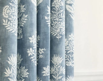 Elevate your windows with this indigo blue drapery features a large-scale floral  a watery blue ground cloth and off-white floral pattern