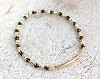 Black onyx faceted round bead and gold nugget bead stretch bracelet
