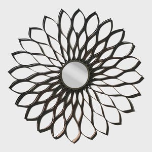 May include: A circular wall mirror featuring a central reflective glass pane surrounded by a dark metal frame. The frame consists of multiple overlapping, petal-shaped loops arranged in a radial pattern, creating a flower-like silhouette.