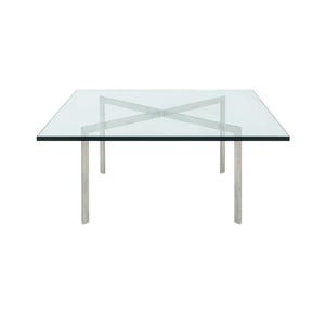 May include: A square glass coffee table with a clear top and four silver metal legs. The legs are cylindrical and the top is supported by an X-shaped metal frame. The table is set against a white background.