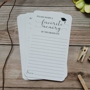 May include: White card with black text that reads "Please share a favorite memory of the graduate."  The card has a black graduation cap icon.  The card has lined space for writing and a space for the person's name at the bottom.