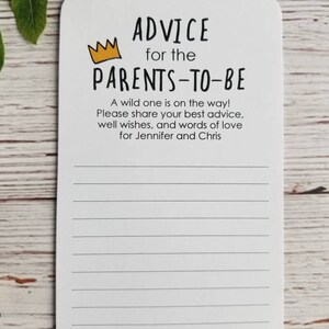 May include: A white card with black text that reads "Advice for the Parents-to-Be". A yellow crown is above the text. The card has lined paper for writing advice for the parents-to-be. The text at the bottom of the card reads "With Love."