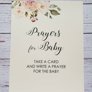 May include: A white card with a floral design at the top. The text reads "Prayers for Baby. Take a card and write a prayer for the baby."