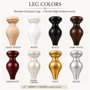 May include: A grid of eight wooden furniture legs, each 10.16 cm high without the screw. The colours include light wood, white, black, dark wood, mahogany, pearl cream, gold, and silver. Each leg features a rounded top and a tapered base.