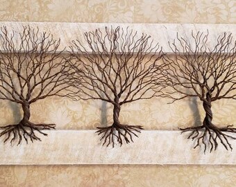 3 brown wire trees on white frame