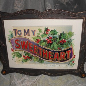 May include: A framed vintage postcard with a holly and berry design. The postcard reads "To My Sweetheart" in gold lettering on a purple and blue banner.