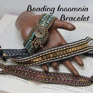 May include: Beaded bracelets in various designs, including one with turquoise beads and a large button clasp. The bracelets are displayed on a wooden hand, with the words "Beading Insomnia Bracelet" visible.