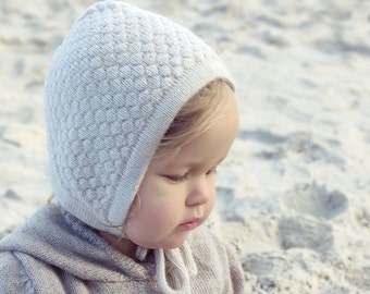 white knitted baby bonnet