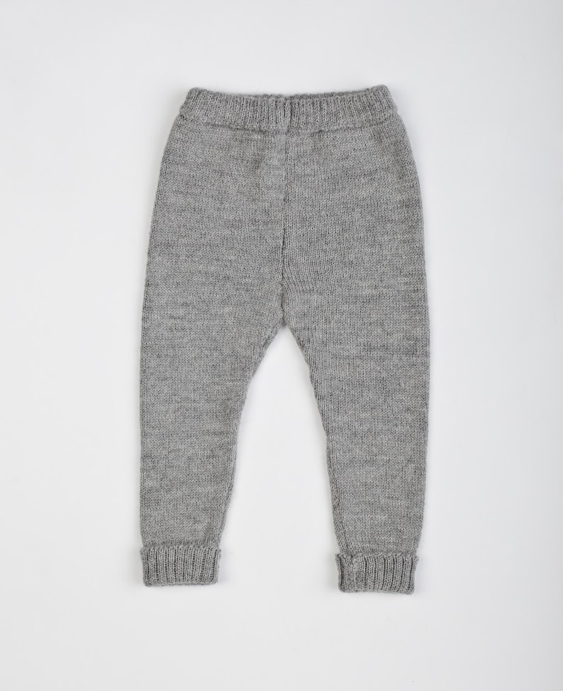 May include: Gray knitted baby leggings with a ribbed texture.