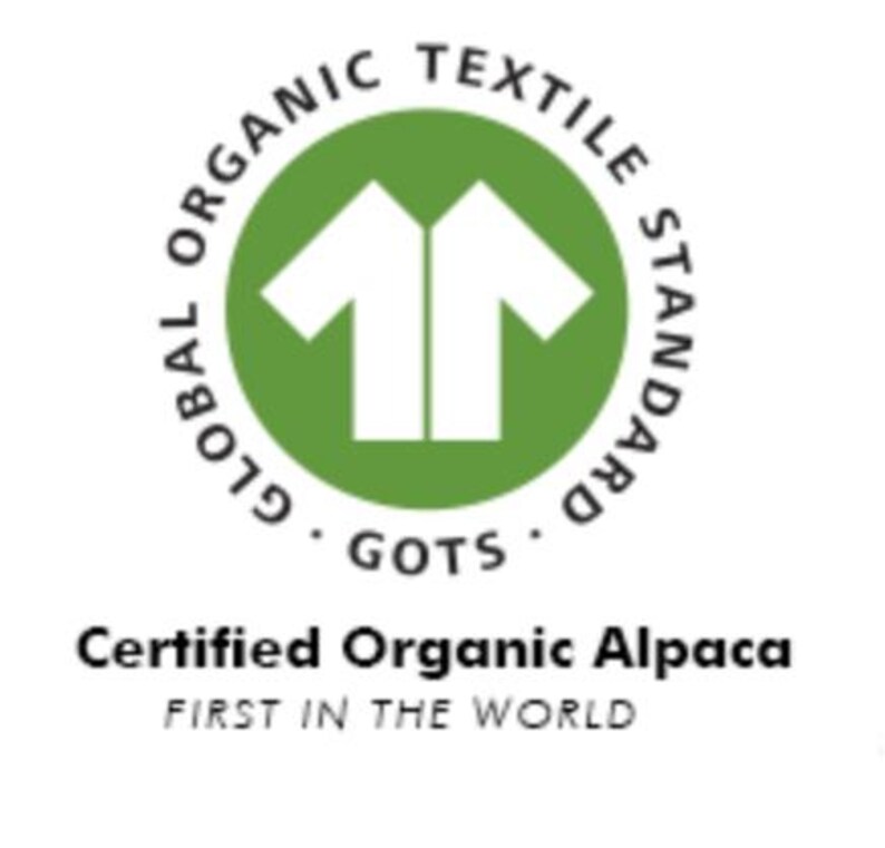 May include: Green circle with the text "Global Organic Textile Standard GOTS" around the edge. Inside the circle is a white silhouette of two t-shirts. Below the circle is the text "Certified Organic Alpaca First in the World."