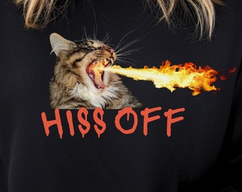 May include: Black sweatshirt with a graphic of a cat breathing fire and the text "HISS OFF" in red.
