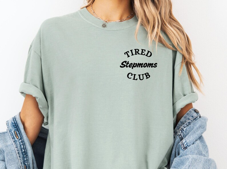 May include: A light green t-shirt with the text "TIRED Stepmoms CLUB" in black lettering.