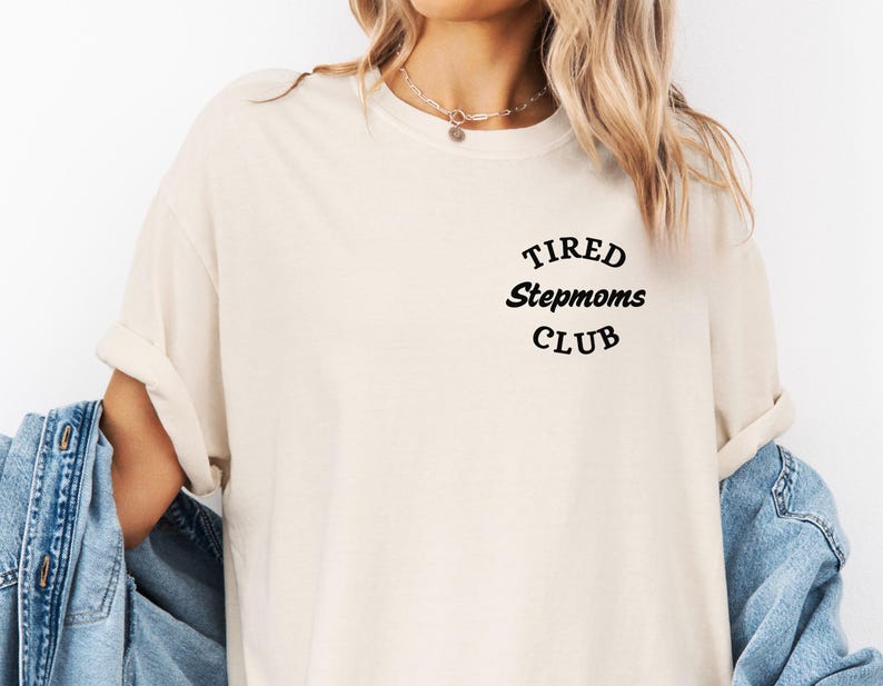 May include: A white t-shirt with the text "TIRED Stepmoms CLUB" in black lettering.