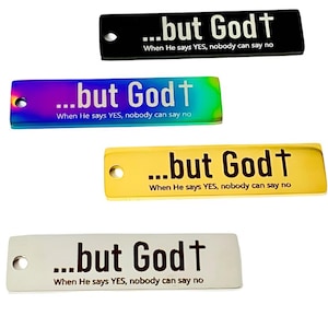 May include: Four different metal tags with the phrase "...but God†" and the text "When He says YES, nobody can say no". The tags are in black, rainbow, gold, and silver.
