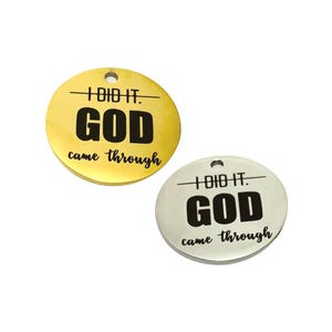 May include: Two round metal tags with the text "I DID IT. GOD came through" in black lettering. One tag is gold and the other is silver.
