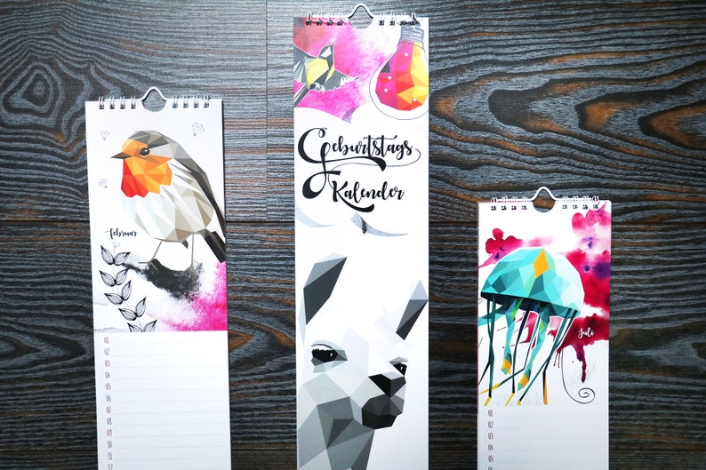 May include: Three different vertical wall calendars with colorful geometric animal illustrations. The calendars feature a robin, a llama, and a jellyfish. The calendars are titled "Geburtstagskalender" which translates to "Birthday Calendar".