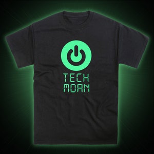 May include: Black t-shirt with a green glow-in-the-dark power button symbol and the text "TECH MOAN" in a digital font.