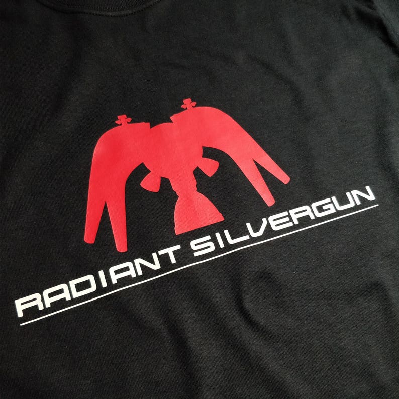 May include: Black t-shirt with a red eagle silhouette and the text "RADIANT SILVERGUN" in white.
