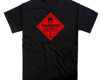May include: Black t-shirt with a red warning sign that says "WARNING EXTREMELY VOLATILE" with a flame symbol and an exclamation point.