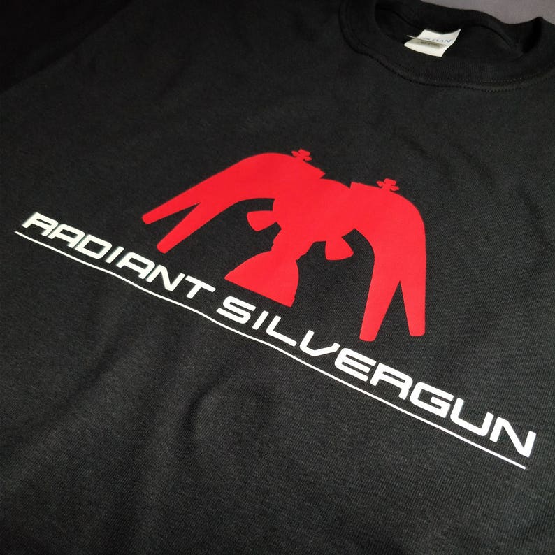 May include: Black t-shirt with a red eagle graphic and the text "RADIANT SILVERGUN" in white.