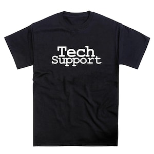 May include: Black t-shirt featuring the white text "Tech Support". The text is in a bold, sans-serif font. The t-shirt has a crew neck and is likely made of cotton or a similar fabric. The image is a studio shot.