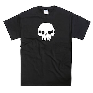 May include: Black t-shirt featuring a white skull graphic. The skull has a simple design with two eye sockets and a toothy grin.