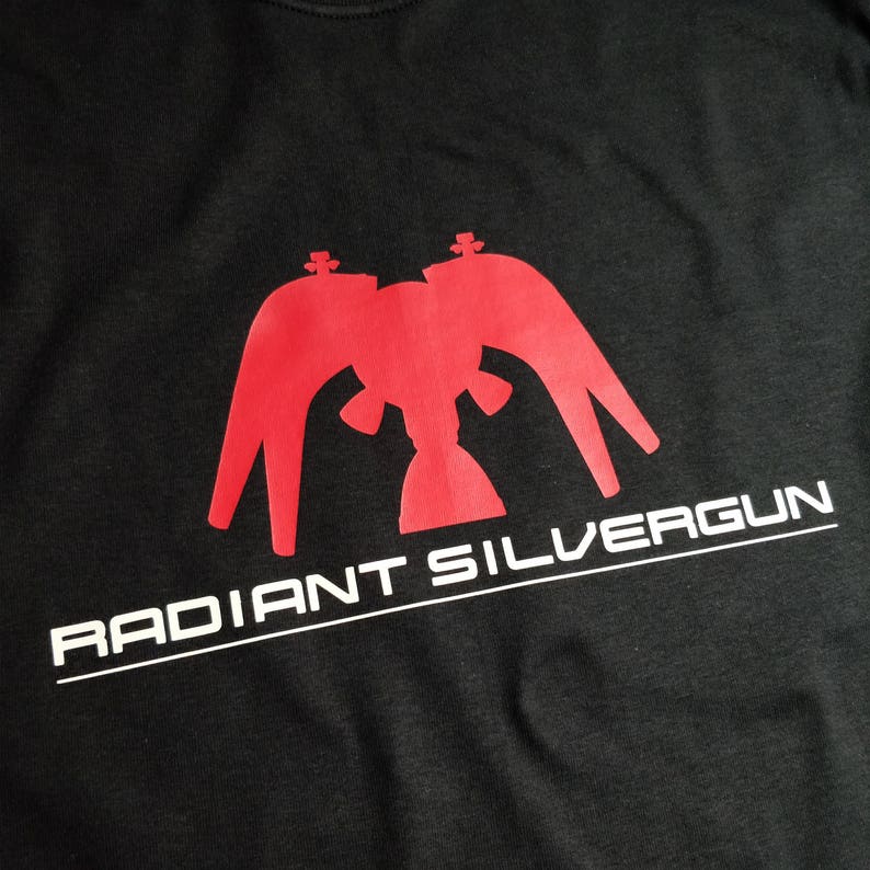 May include: Black t-shirt with a red graphic of a stylized eagle with the text "RADIANT SILVERGUN" in white.