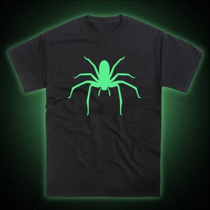 May include: Black t-shirt with a glow-in-the-dark green spider graphic.