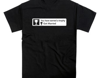 May include: Black t-shirt with a white graphic that says "You have earned a trophy Got Married" with a trophy icon.