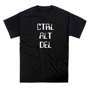 May include: Black t-shirt with the white text "CTRL ALT DEL" stacked vertically. The shirt is a crew neck style and appears to be made of a soft material. The text is in a bold, sans-serif font.
