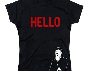 May include: Black t-shirt with the word "HELLO" in red letters and a white silhouette of a man with a mustache looking thoughtful.