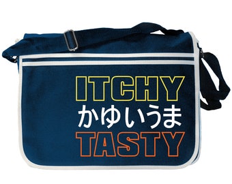 May include: A navy blue messenger bag with a white trim. The bag has the text "ITCHY" in yellow, "かわいいま" in white, and "TASTY" in orange.