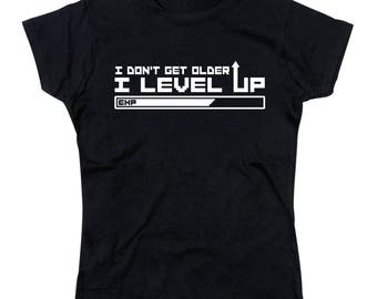 May include: Black t-shirt with white text that reads "I don't get older I level up" with a progress bar that says "EXP" underneath.