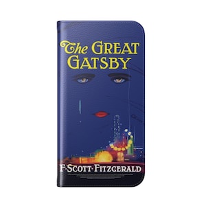 May include: A blue phone case featuring the cover art of "The Great Gatsby" by F. Scott Fitzgerald. The design includes a stylized face, the title in yellow, and a cityscape illustration.