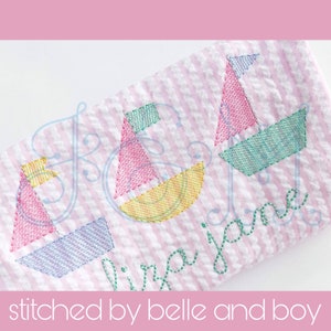 May include: A pink and green embroidered design of three sailboats with the text "Virginia Jane" stitched below. The design is on a pink and white striped fabric.