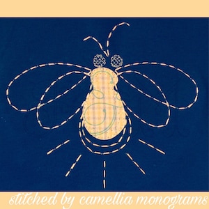 May include: A yellow and white gingham firefly with a stitched design on a dark blue background. The firefly has a stitched outline and a light yellow glow around it. The text "stitched by camellia monograms" is at the bottom of the image.