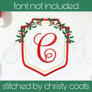 May include: Embroidered monogram with a holly wreath design. The letter "C" is in the centre of the design, surrounded by red and green embroidery.