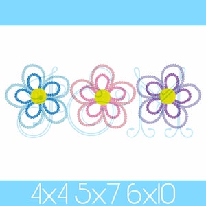 May include: Three embroidered flower designs in blue, pink, and purple with yellow centers. The flowers have a layered, open design with a stitched outline. The text "4x4 5x7 6x10" is at the bottom, indicating sizes.