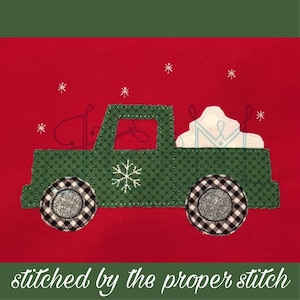 May include: A green truck with a white snowflake on the side is carrying a white snowdrift in the back. The truck has black and white checkered wheels and is on a red background with white snowflakes.