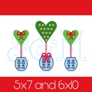 May include: Three embroidered heart-shaped ornaments with a Chinese double happiness symbol on a blue and white background. The hearts are green with pink polka dots, green with a red bow, and green with a red bow. The ornaments are 5x7 and 6x10 inches.