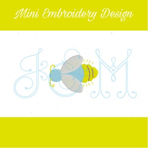 May include: A light blue and yellow embroidered bee design with the text "Mini Embroidery Design". The design includes the letters J, K, and M in a light blue, cursive font. The bee has yellow and purple stripes.