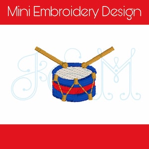 May include: A blue and red toy drum with gold sticks. The drum has a white center and a red stripe around the middle. The sticks are crossed over the top of the drum.
