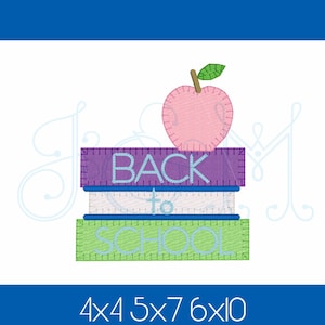 May include: An embroidered design showing a stack of three books with the words "BACK TO SCHOOL" in light blue. A pink apple with a green leaf sits on top. The design uses purple, green, and blue colours.